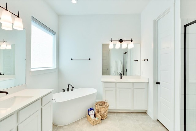 bathroom with a sink, a soaking tub, two vanities, and tile patterned floors