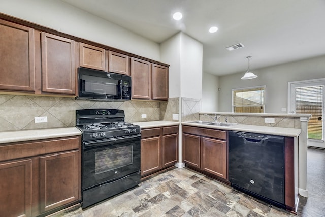 kitchen with visible vents, black appliances, a sink, a peninsula, and light countertops