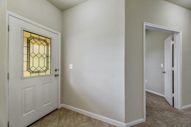 foyer with baseboards and light tile patterned flooring