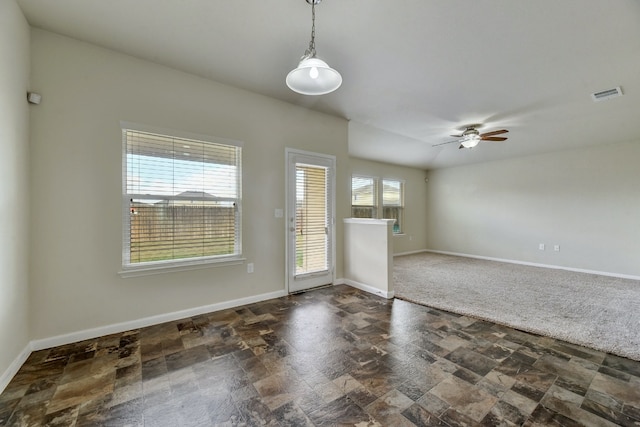 unfurnished room featuring visible vents, baseboards, a ceiling fan, and stone finish flooring