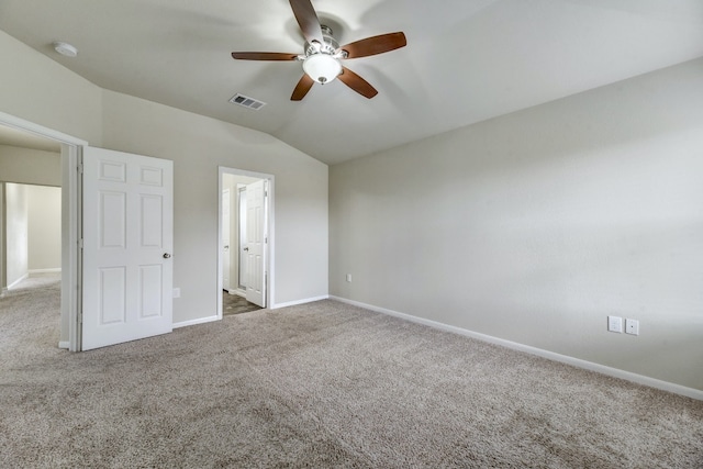 unfurnished bedroom featuring visible vents, a ceiling fan, baseboards, carpet, and lofted ceiling