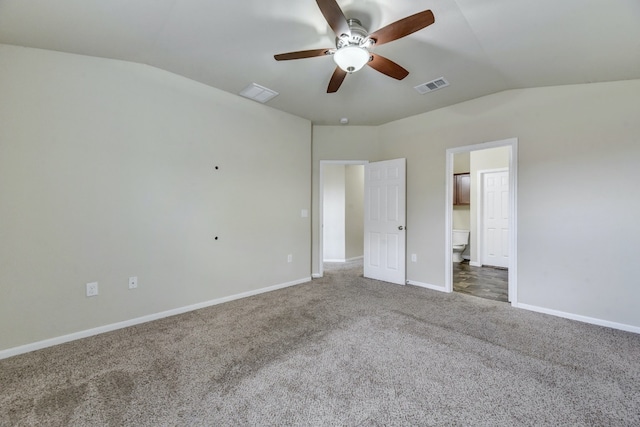 unfurnished bedroom with lofted ceiling, carpet, visible vents, and baseboards