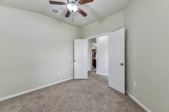 unfurnished bedroom with visible vents, light colored carpet, baseboards, and ceiling fan