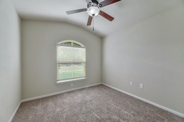 carpeted spare room featuring baseboards, a ceiling fan, and vaulted ceiling