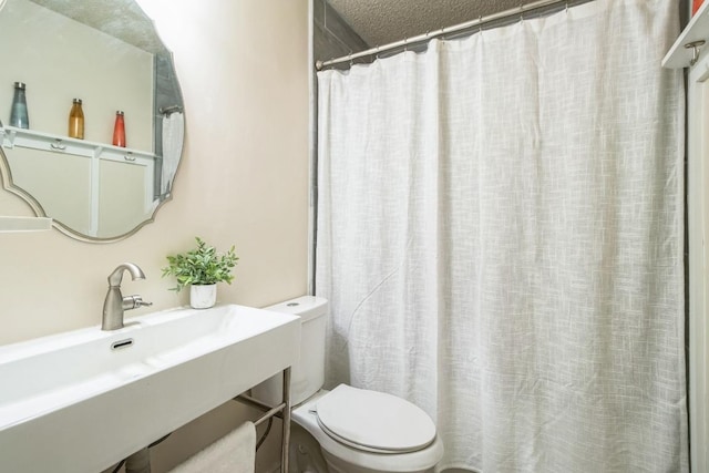 bathroom with a sink, a shower with curtain, and toilet