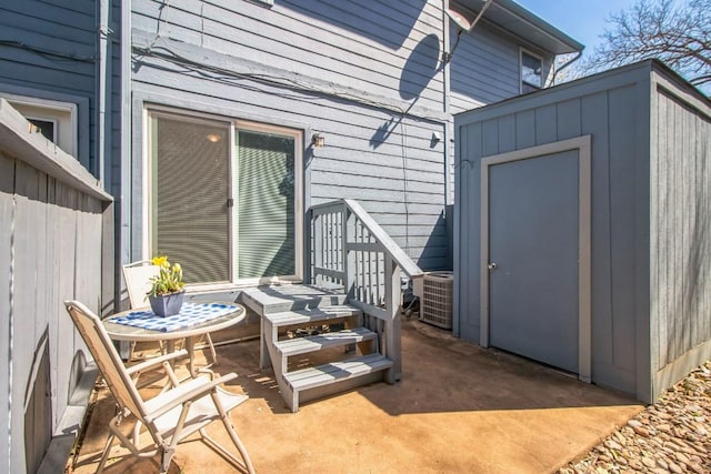 view of patio / terrace featuring an outbuilding and a storage shed