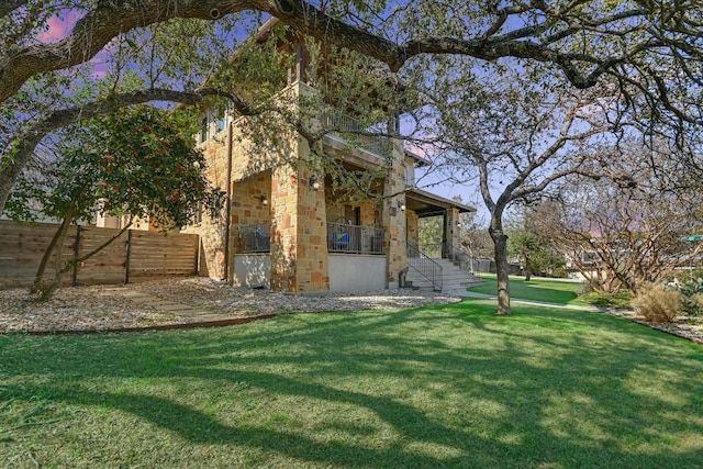 view of yard featuring covered porch and fence