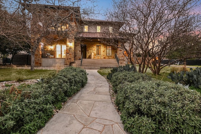 view of front facade featuring stone siding and a porch