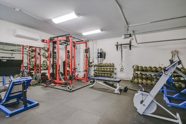 workout area featuring a wall unit AC and a garage