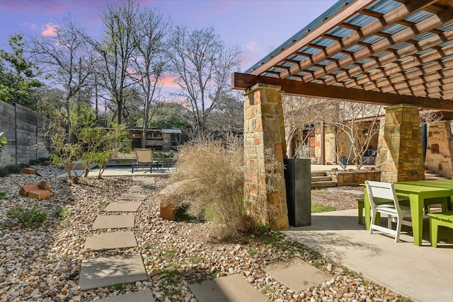 view of home's community featuring a patio area, a pergola, outdoor dining area, and fence