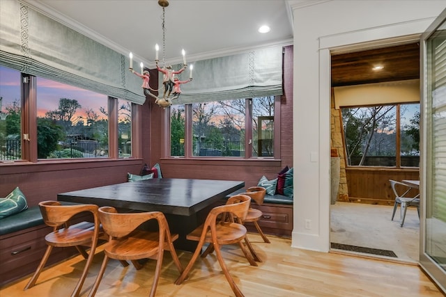 dining area featuring a wealth of natural light, breakfast area, crown molding, and an inviting chandelier