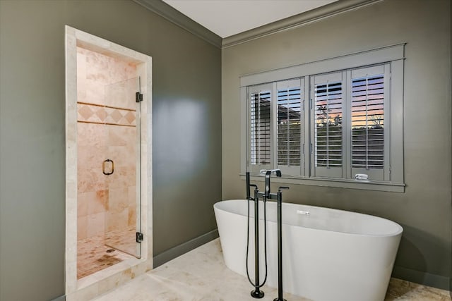 full bath with a soaking tub, a shower stall, crown molding, and baseboards