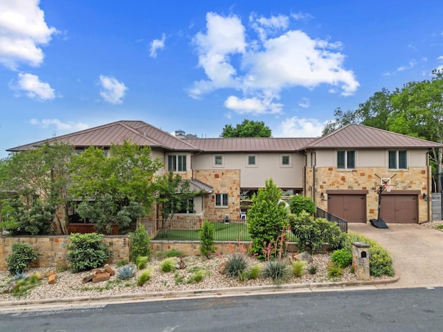 4513 Spanish Oak Trl, Austin, TX 78731 - view of front of house with a standing seam roof, metal roof, a fenced front yard, and driveway