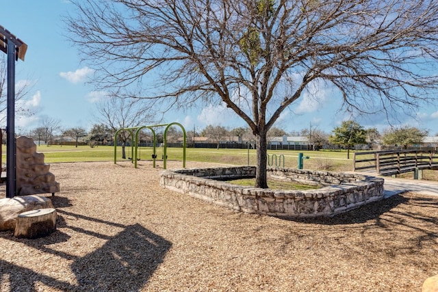 view of yard featuring playground community and fence