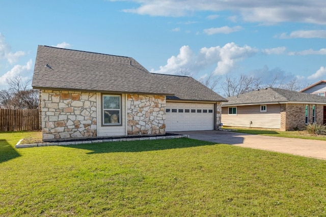 view of front of house featuring an attached garage, fence, a front yard, stone siding, and driveway