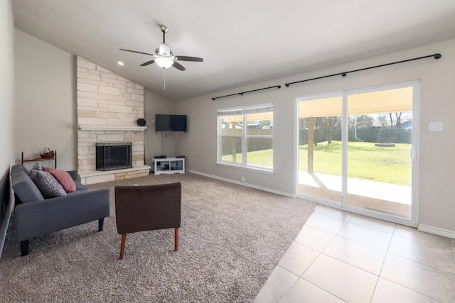 living area with lofted ceiling, light tile patterned floors, a fireplace, and a wealth of natural light