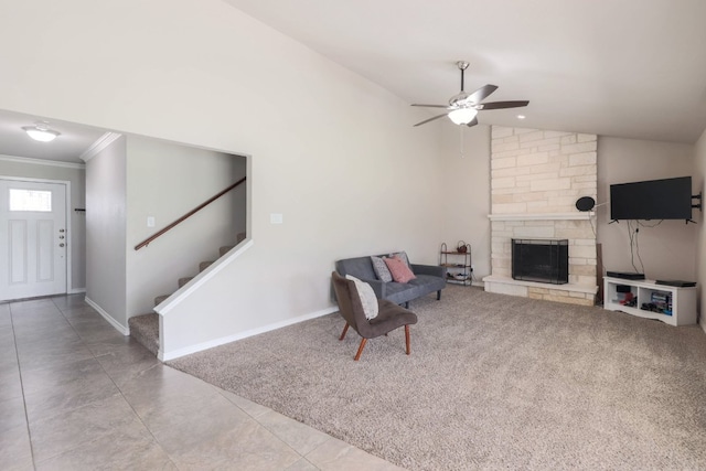 carpeted living area featuring baseboards, a fireplace, ceiling fan, stairs, and crown molding