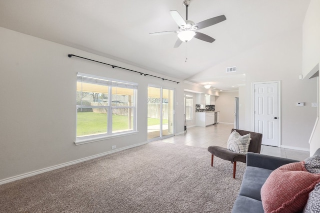 living area featuring visible vents, baseboards, light carpet, high vaulted ceiling, and a ceiling fan