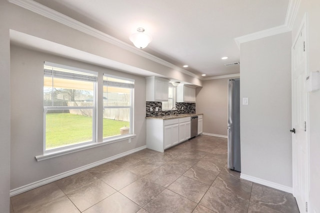 kitchen featuring baseboards, visible vents, stainless steel appliances, decorative backsplash, and crown molding