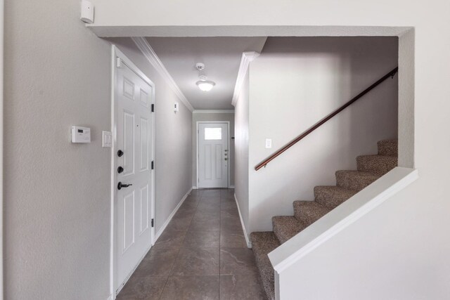 doorway featuring stairs, crown molding, and baseboards