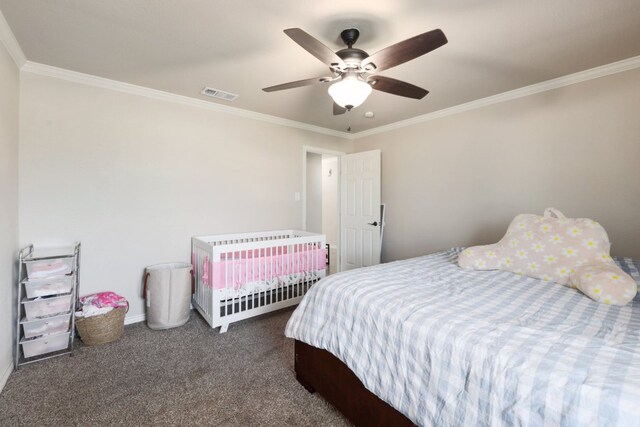 carpeted bedroom featuring visible vents, baseboards, crown molding, and a ceiling fan