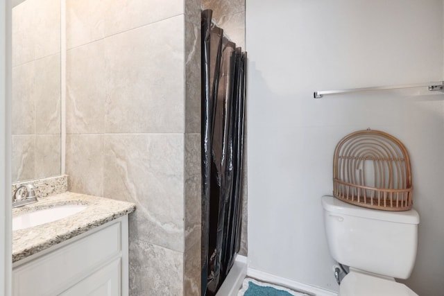 full bath with curtained shower, toilet, tile walls, and vanity