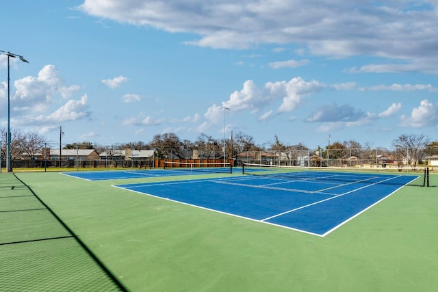 view of sport court featuring fence