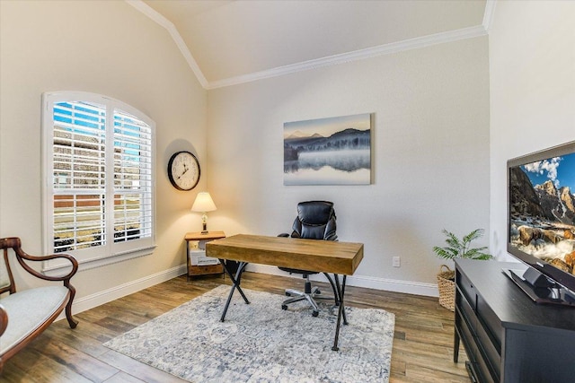 office area featuring vaulted ceiling, wood finished floors, baseboards, and ornamental molding