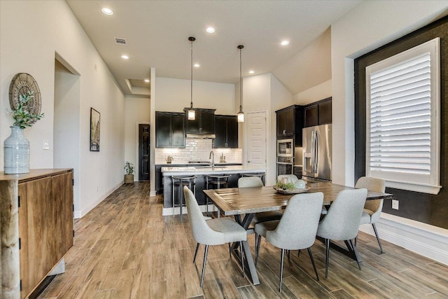 dining room with recessed lighting, visible vents, baseboards, and light wood finished floors