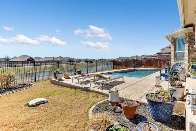 view of swimming pool with a water view, a patio, a fenced backyard, a yard, and a fenced in pool