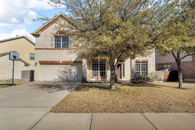 view of front of home with concrete driveway, a garage, stone siding, and a front lawn