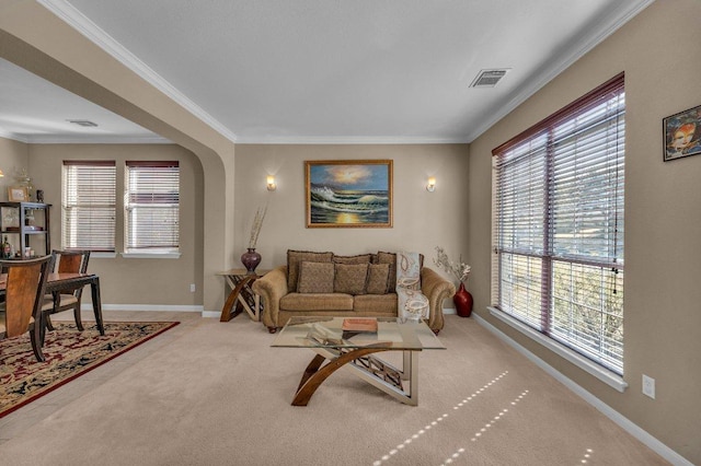 living room with carpet flooring, arched walkways, visible vents, and a wealth of natural light