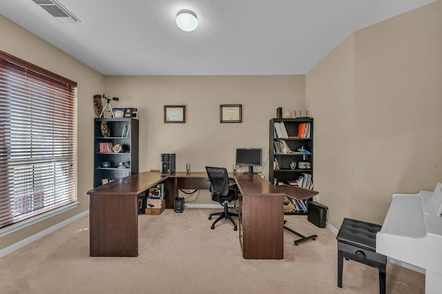 office area featuring carpet flooring, baseboards, and visible vents