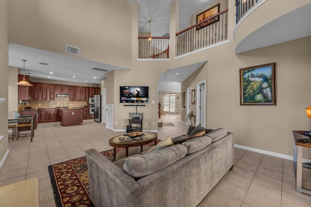 living room with visible vents, baseboards, and light tile patterned flooring