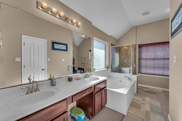 bathroom with a sink, a garden tub, a stall shower, and vaulted ceiling