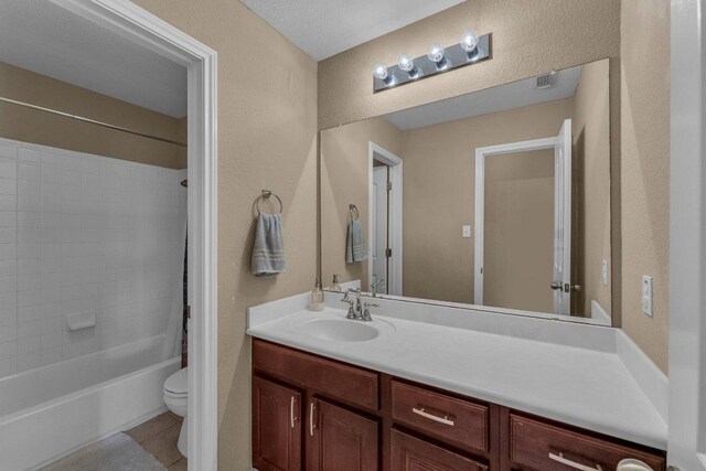 full bath featuring tile patterned floors, visible vents, toilet, shower / tub combination, and vanity