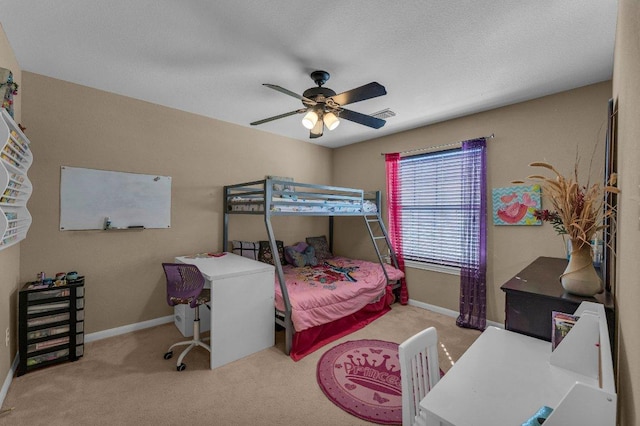 carpeted bedroom featuring visible vents, baseboards, and ceiling fan