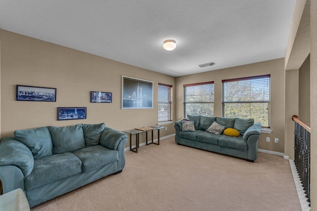 living area featuring visible vents, baseboards, and light colored carpet