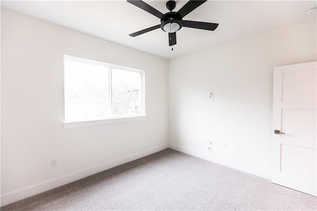 spare room featuring ceiling fan, baseboards, and carpet