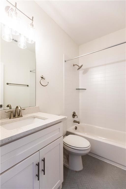 bathroom featuring shower / bathing tub combination, toilet, and vanity