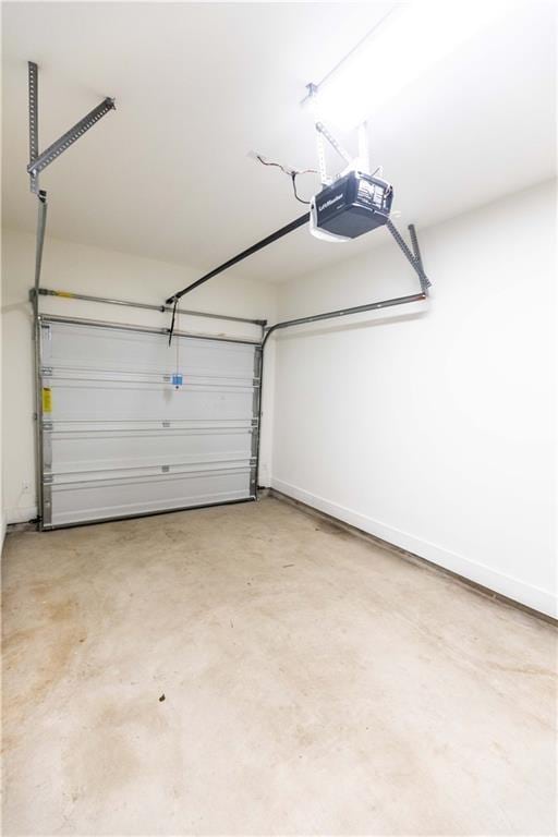 garage featuring baseboards and a garage door opener