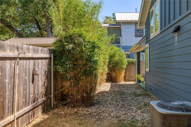 view of yard featuring cooling unit and fence