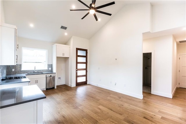 409 W 35th St Unit B, Austin, TX 78705 - kitchen featuring a sink, a ceiling fan, high vaulted ceiling, stainless steel dishwasher, and white cabinets