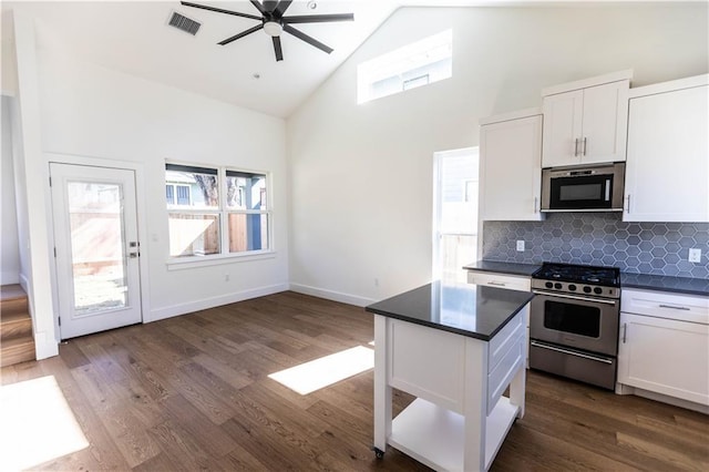 409 W 35th St Unit B, Austin, TX 78705 - kitchen featuring stainless steel gas range, high vaulted ceiling, dark countertops, ceiling fan, and white cabinets
