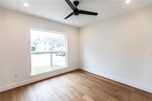 spare room featuring visible vents, ceiling fan, baseboards, recessed lighting, and wood finished floors