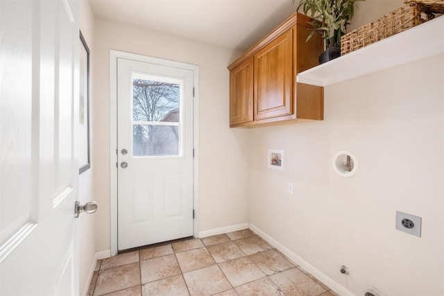 clothes washing area with baseboards, washer hookup, hookup for a gas dryer, cabinet space, and electric dryer hookup