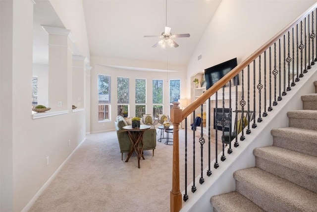 stairs with visible vents, high vaulted ceiling, a ceiling fan, carpet flooring, and baseboards