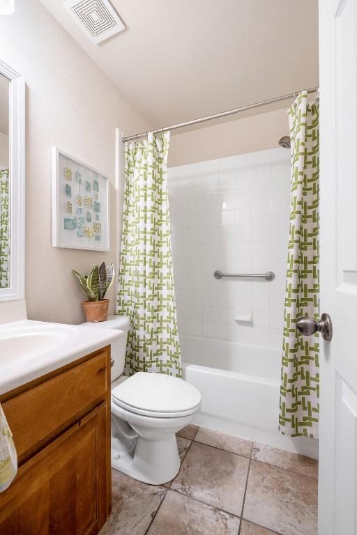 full bath with vanity, visible vents, shower / bath combo with shower curtain, tile patterned floors, and toilet