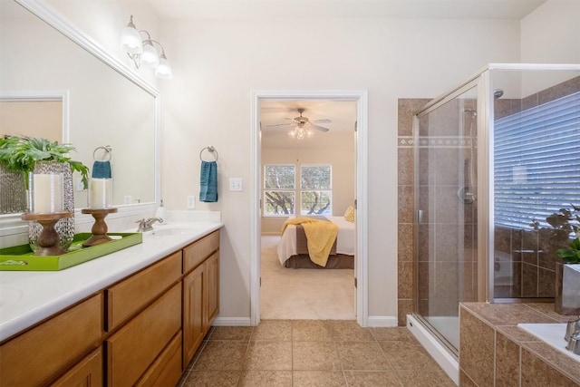 ensuite bathroom featuring a shower stall, a relaxing tiled tub, ensuite bath, tile patterned floors, and vanity