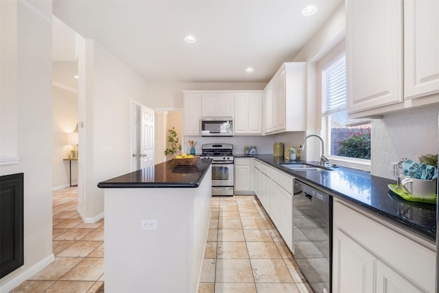 kitchen featuring a sink, a center island, white cabinetry, recessed lighting, and appliances with stainless steel finishes